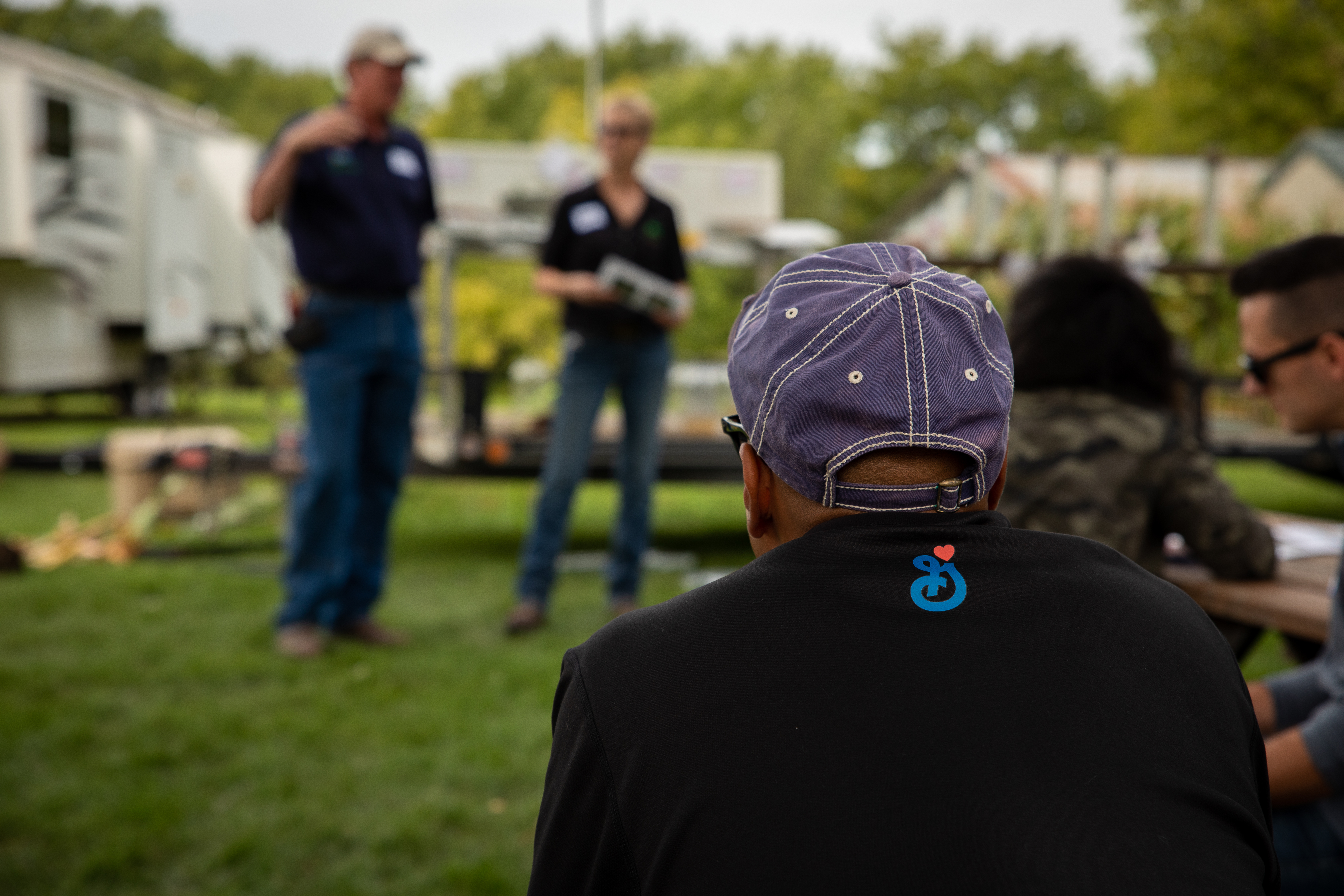 Employee listening to presentation with a General Mills logo on their shirt